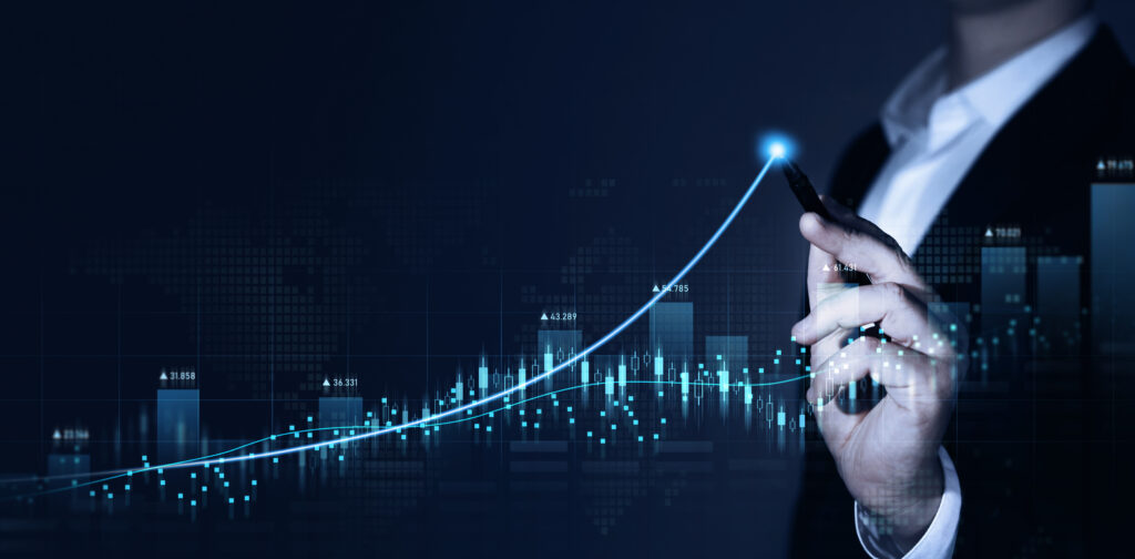 A businessperson in a suit draws an upward-trending digital growth curve on a virtual screen, representing increasing business value and performance. The image symbolizes strategic planning and the power of valuation insights to drive growth and future success.