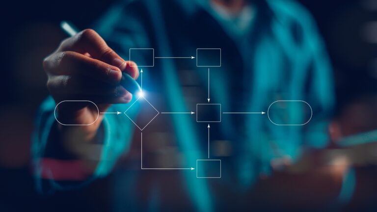 A close-up of a hand drawing a digital flowchart with glowing lines and geometric shapes, representing a structured business process or model. The image symbolizes strategic planning and operational clarity—highlighting the importance of understanding how a business functions beyond the financials. It visually reinforces the blog’s message that the true value of a company lies in its underlying systems, not just in its numbers.