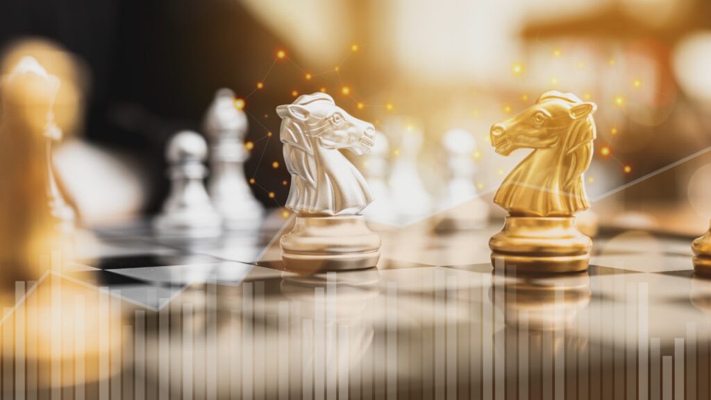 Gold and silver knight chess pieces face off on a chessboard, illuminated by a warm strategic glow. A symbolic representation of two competing buyer types—Strategic and Financial—each with distinct motives and tactics. Subtle data visuals overlay the scene, reinforcing the calculated nature of M&A decisions. This image underscores the need for sellers to think several moves ahead when choosing the right buyer for their business.