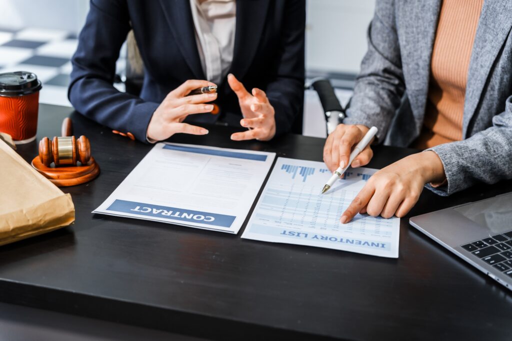 Business owner and advisor reviewing financial statements and due diligence documents before selling a business to prepare for an M&A transaction.