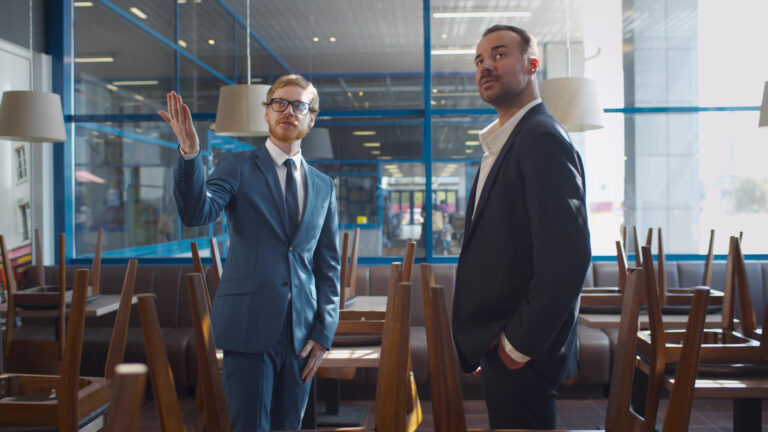 Business acquisition professionals evaluating a commercial property during due diligence to align commercial real estate strategy with a successful business acquisition.