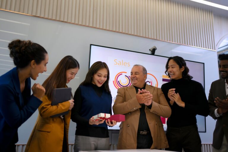 Business owner introducing new leadership to employees during a company meeting, demonstrating effective communication, employee retention, and business transition planning during the sale of a business.