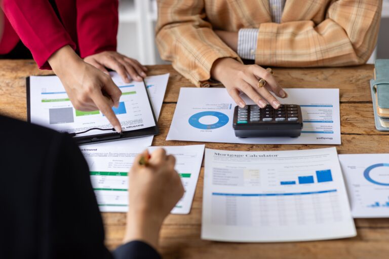 Business owners and M&A advisors reviewing financial reports, business valuation data, and acquisition strategies to determine the best buyer type—strategic, financial, or individual—for maximizing business value and sale price.