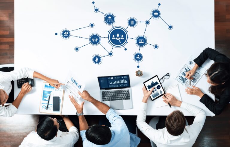 Business professionals analyzing financial reports and digital dashboards during a strategic planning meeting on industry roll-ups and mergers and acquisitions